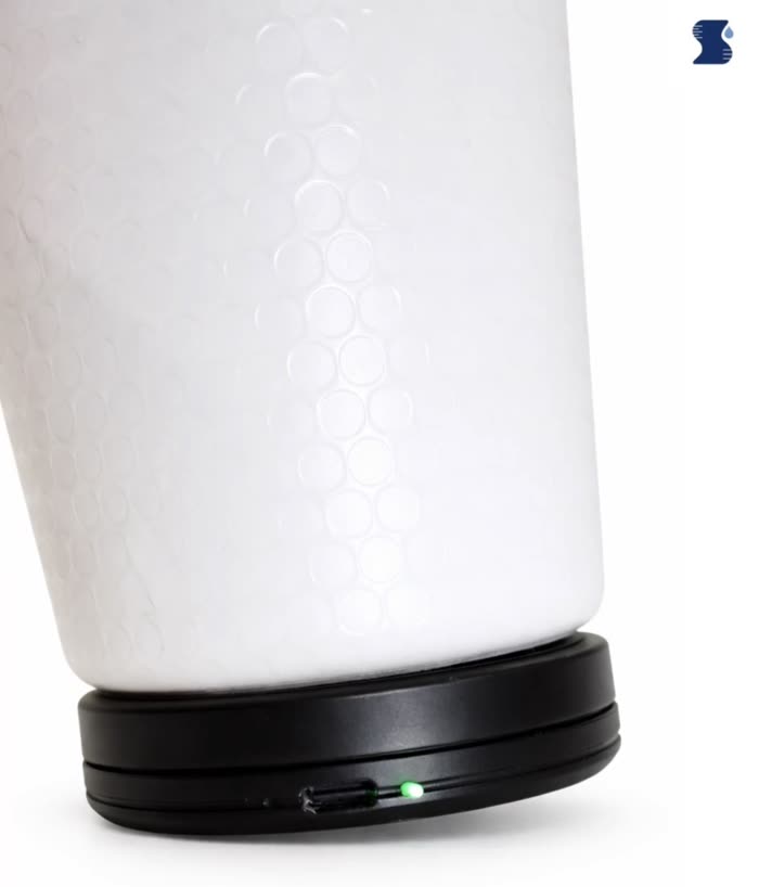 The Sponge Clip attached around the base of a water bottle, its status light lit green